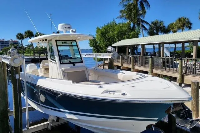 The Image of 2018 Boston Whaler 280 Outrage docked, featuring sleek design and advanced navigation equipment. - 0