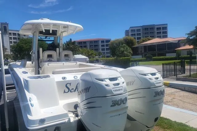 Slide: The Image of 2018 Boston Whaler 280 Outrage boat with twin Mercury 300 engines, parked near residential buildings. - 3