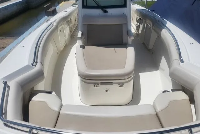 Slide: The Image of 2018 Boston Whaler 280 Outrage boat interior with cushioned seating and sleek design. - 7