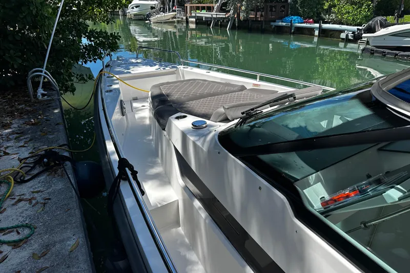 Slide: The Image of 2018 Axopar 37 Sun-Top boat docked in a serene canal setting. - 23