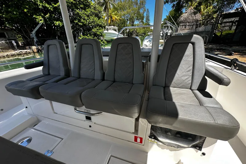 Slide: The Image of 2018 Axopar 37 Sun-Top boat interior with four gray cushioned seats. - 25