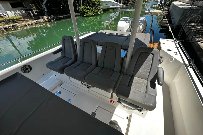 Slide: The Image of 2018 Axopar 37 Sun-Top boat interior with gray seating and sleek design. - 26