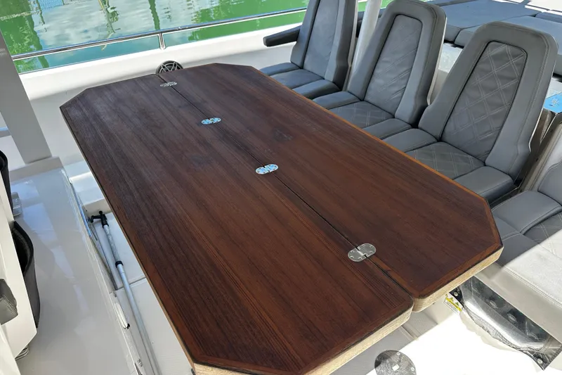 Slide: The Image of Luxury seating and wooden table on 2018 Axopar 37 Sun-Top boat. - 27