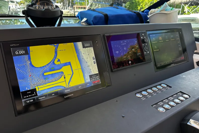 Slide: The Image of Dashboard of a 2018 Axopar 37 Sun-Top with navigation screens and controls. - 30
