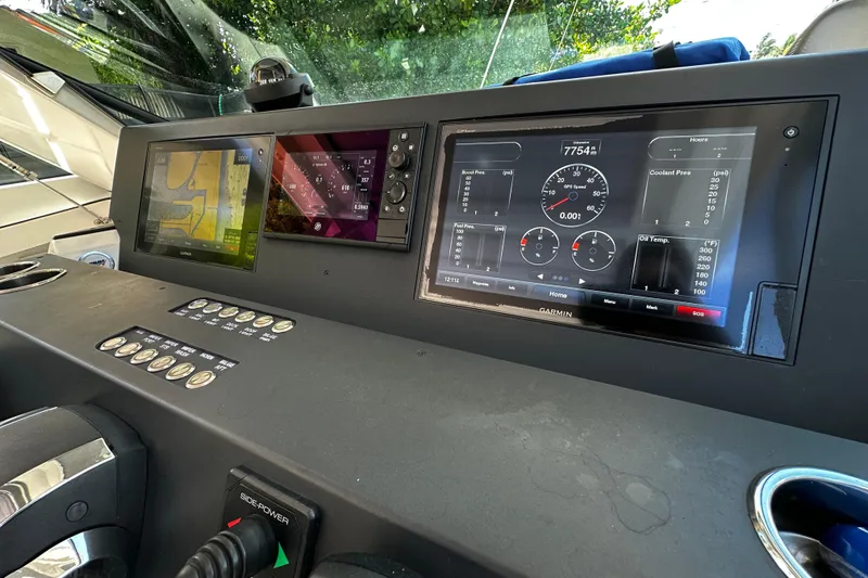Slide: The Image of Dashboard of a 2018 Axopar 37 Sun-Top with navigation and control screens. - 31