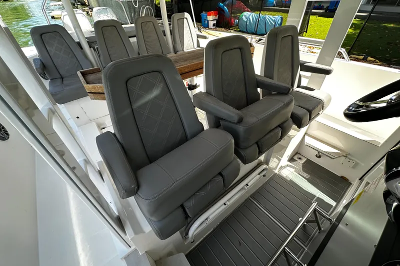 Slide: The Image of Interior seating of 2018 Axopar 37 Sun-Top boat with gray cushioned chairs. - 34