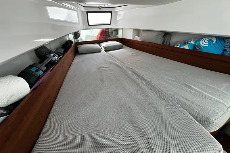 Slide: The Image of Cozy cabin interior of 2018 Axopar 37 Sun-Top with comfortable bedding and storage. - 35
