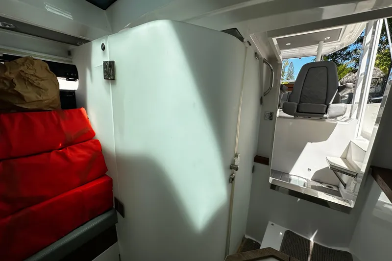 Slide: The Image of Interior view of 2018 Axopar 37 Sun-Top boat, featuring seating and storage area. - 37
