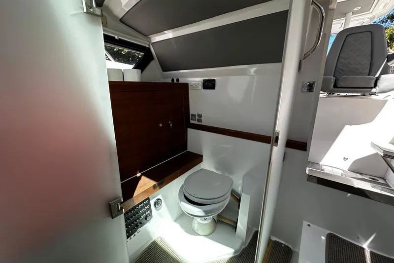 Slide: The Image of 2018 Axopar 37 Sun-Top boat interior bathroom with modern amenities and sleek design. - 39