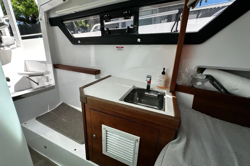 Slide: The Image of 2018 Axopar 37 Sun-Top interior with compact sink and wooden cabinetry. - 40