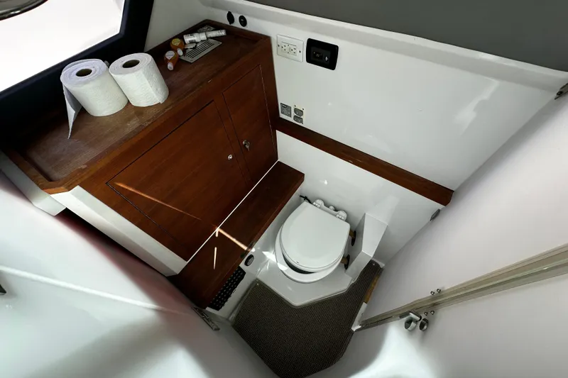 Slide: The Image of Compact bathroom in 2018 Axopar 37 Sun-Top boat with toilet and wooden cabinet. - 41