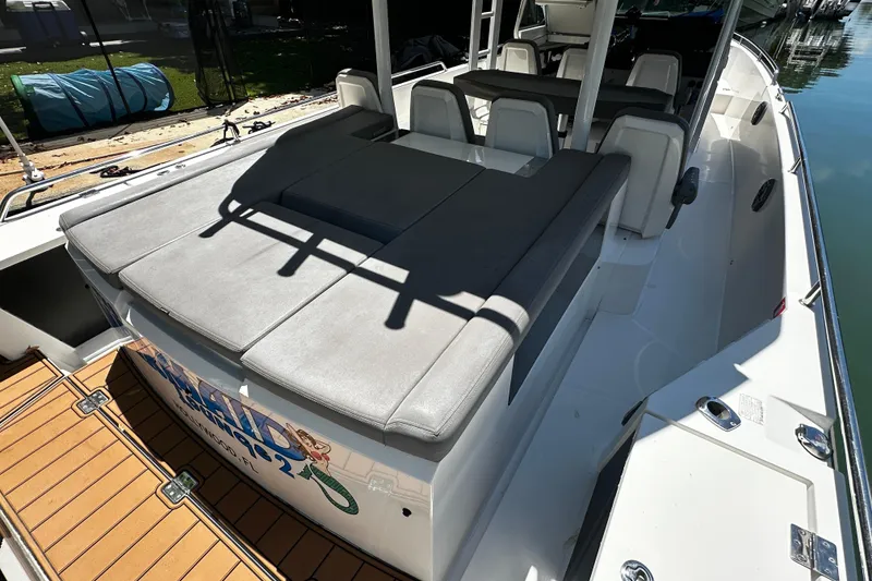 Slide: The Image of 2018 Axopar 37 Sun-Top boat with spacious seating and sleek design. - 42