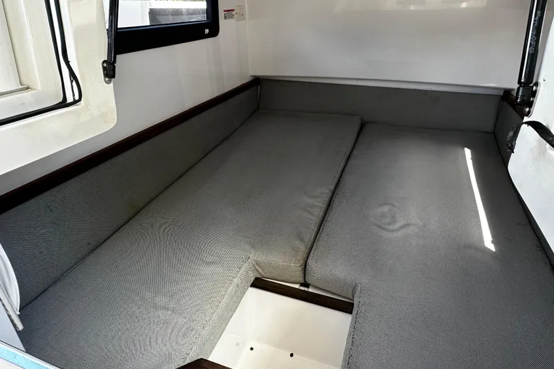 Slide: The Image of Interior cabin of 2018 Axopar 37 Sun-Top with gray cushions and window. - 46
