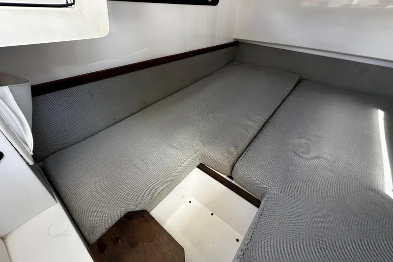 Slide: The Image of 2018 Axopar 37 Sun-Top cabin interior with gray cushioned seating. - 47