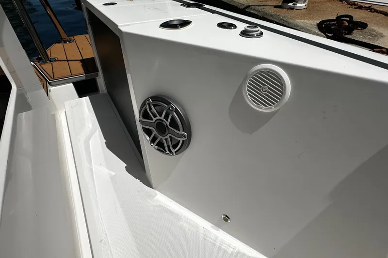 Slide: The Image of 2018 Axopar 37 Sun-Top boat deck with speakers and sleek white design. - 51