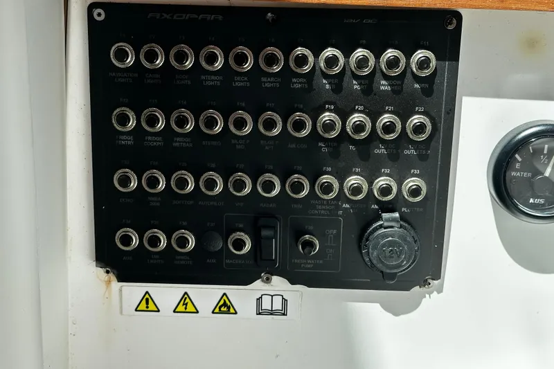 Slide: The Image of Control panel of 2018 Axopar 37 Sun-Top boat with various switches and gauges. - 53