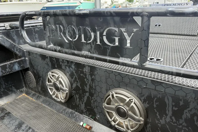 Slide: The Image of 2024 Prodigy 17 boat interior with speakers and textured flooring. - 13