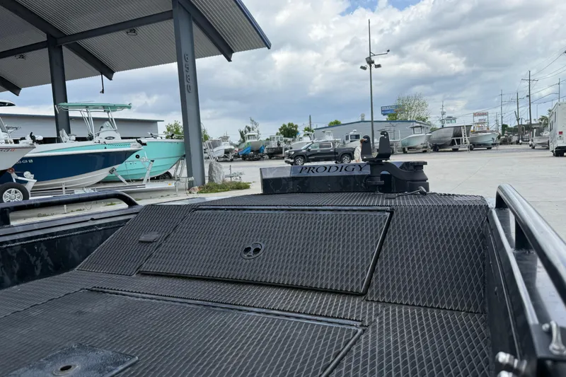 Slide: The Image of Outdoor display of 2024 Prodigy 17 boat at a dealership with other boats. - 14