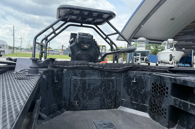 Slide: The Image of 2024 Prodigy 17 boat interior with steering and seating, displayed outdoors. - 15