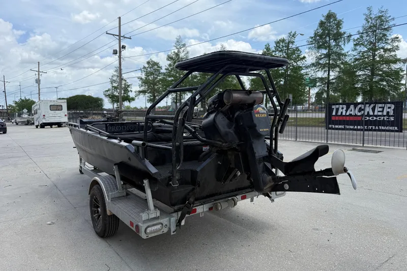 Slide: The Image of 2024 Prodigy 17 boat on trailer, outdoor setting, overcast sky, Tracker Boats sign visible. - 5