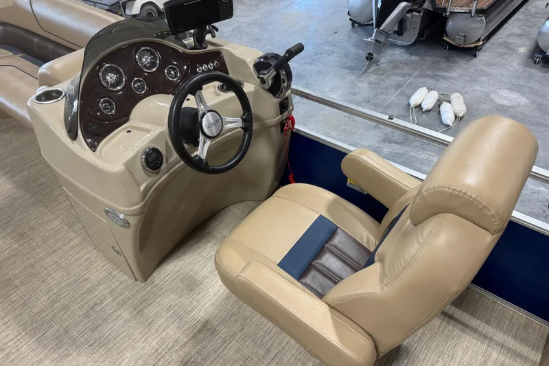 Slide: The Image of Captain's seat and dashboard of a 2017 Lowe SS 250 boat, featuring steering wheel and controls. - 10