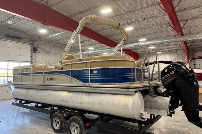 Slide: The Image of 2017 Lowe SS 250 pontoon boat with Mercury engine in indoor storage. - 3