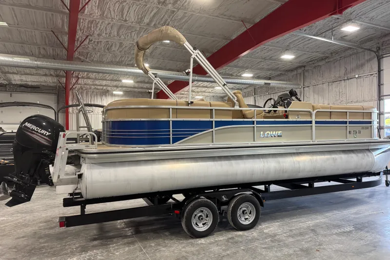 Slide: The Image of 2017 Lowe SS 250 pontoon boat on trailer in indoor storage facility. - 4