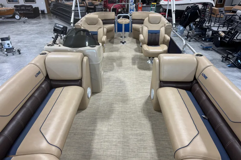 Slide: The Image of Interior of a 2017 Lowe SS 250 pontoon boat with beige and brown seating. - 6