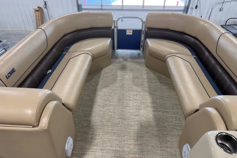 Slide: The Image of Interior of a 2017 Lowe SS 250 pontoon boat with beige and brown seating. - 7