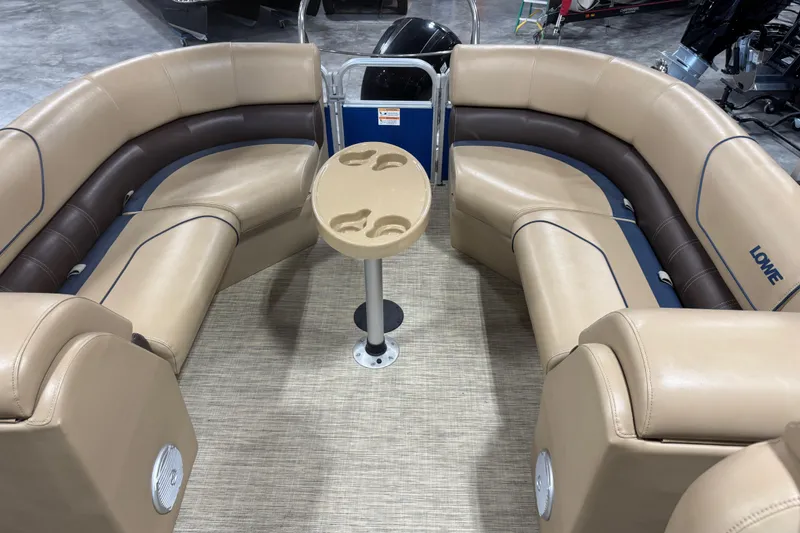Slide: The Image of Luxurious seating area on a 2017 Lowe SS 250 pontoon boat with beige upholstery. - 9