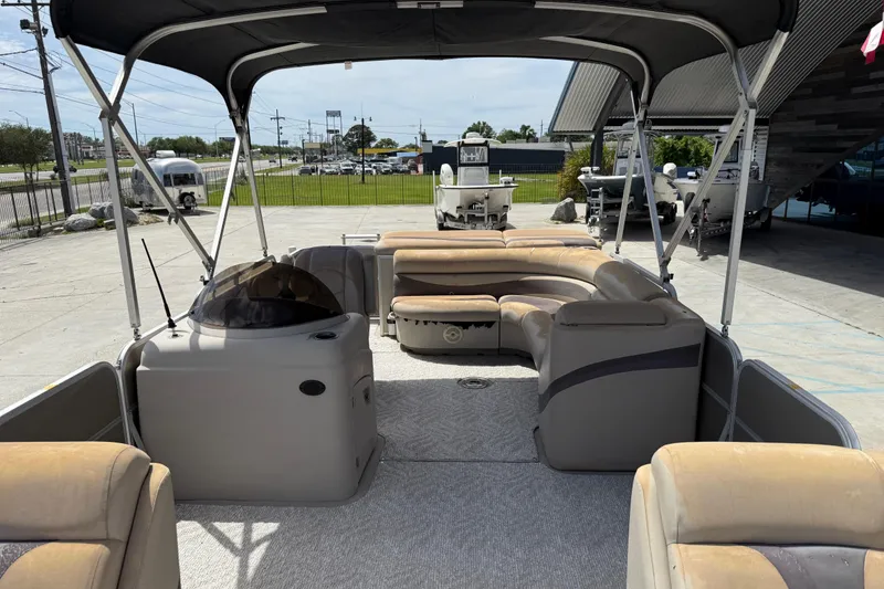 Slide: The Image of 2012 South Bay 522 CR pontoon boat with spacious seating and canopy in a marina setting. - 12