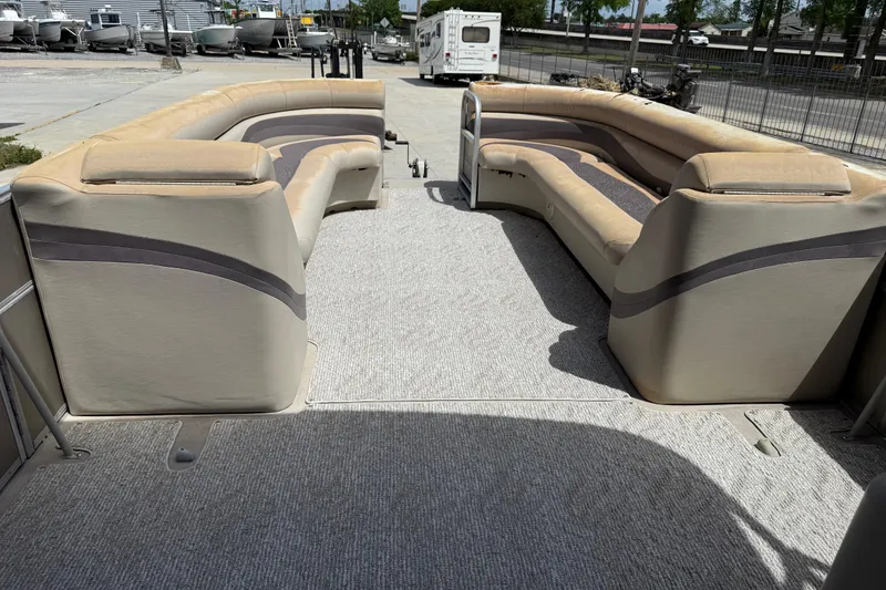 Slide: The Image of 2012 South Bay 522 CR pontoon boat interior with beige seating and carpeted floor. - 14