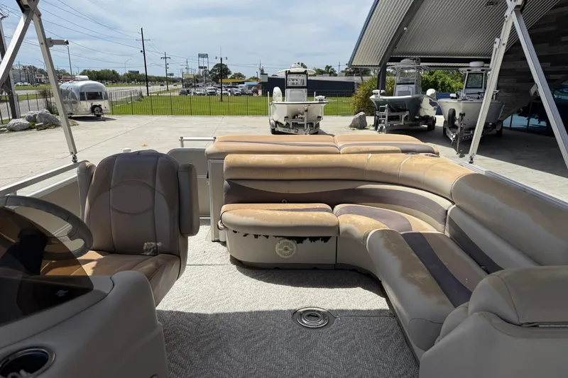 Slide: The Image of 2012 South Bay 522 CR pontoon boat interior with beige seating and steering console. - 15