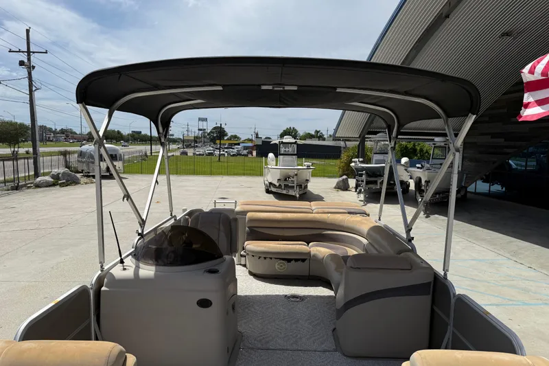 Slide: The Image of 2012 South Bay 522 CR pontoon boat with canopy, parked outdoors near dealership. - 16