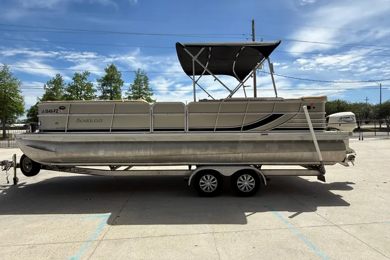 Slide: The Image of 2012 South Bay 522 CR pontoon boat on trailer under clear sky. - 6