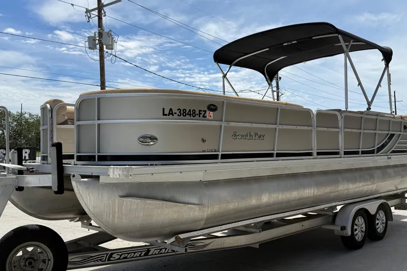 Slide: The Image of 2012 South Bay 522 CR pontoon boat on trailer under blue sky. - 7