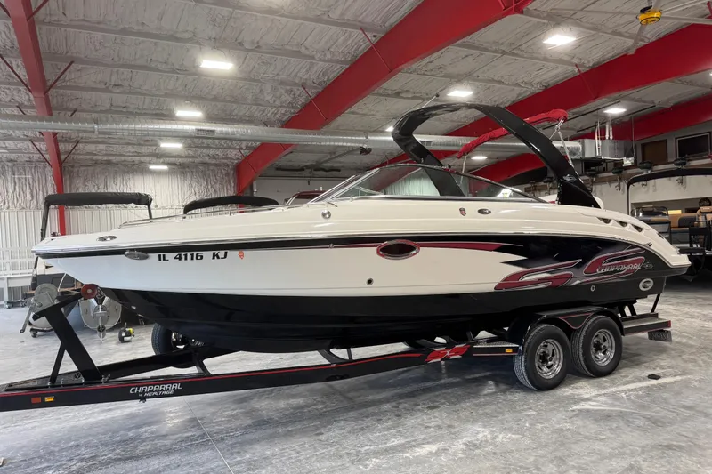 The Image of 2010 Chaparral 256 SSX boat on trailer in indoor storage facility. - 1