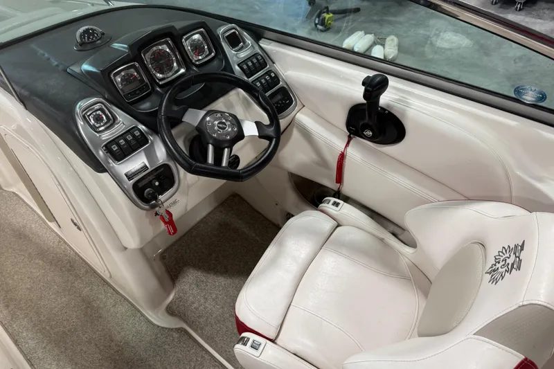 Slide: The Image of 2010 Chaparral 256 SSX boat cockpit with steering wheel and control panel. - 10