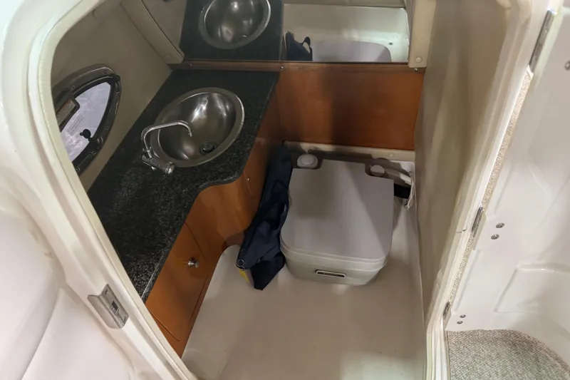 Slide: The Image of 2010 Chaparral 256 SSX boat interior with sink and portable toilet. - 12