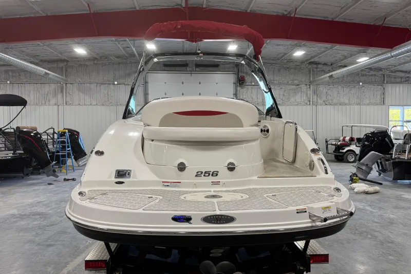Slide: The Image of 2010 Chaparral 256 SSX boat in a spacious indoor storage facility. - 5