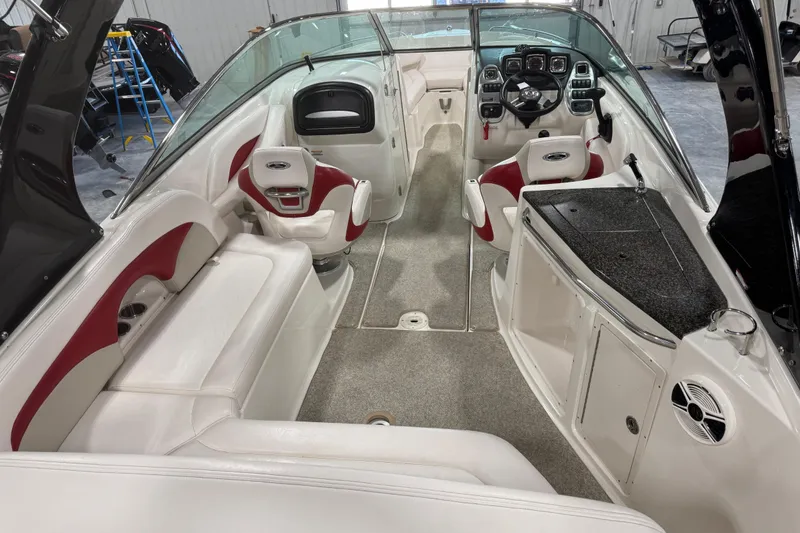 Slide: The Image of Interior of a 2010 Chaparral 256 SSX boat with white and red seating. - 6