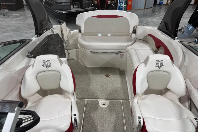 Slide: The Image of 2010 Chaparral 256 SSX boat interior with white and red seating, spacious layout. - 7