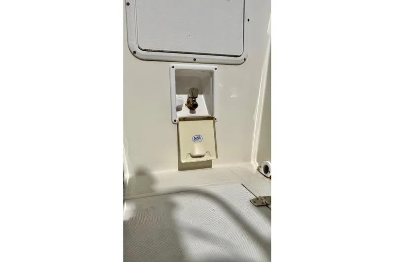 Slide: The Image of 2006 Osprey Legend boat interior detail with utility compartment and SSI label. - 10