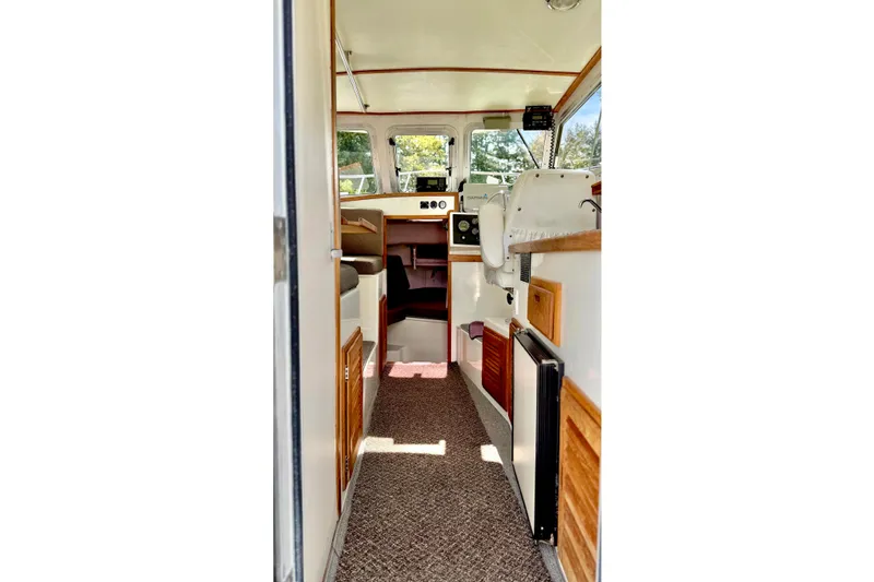 Slide: The Image of Interior view of a 2006 Osprey Legend boat, featuring a compact cabin layout. - 12