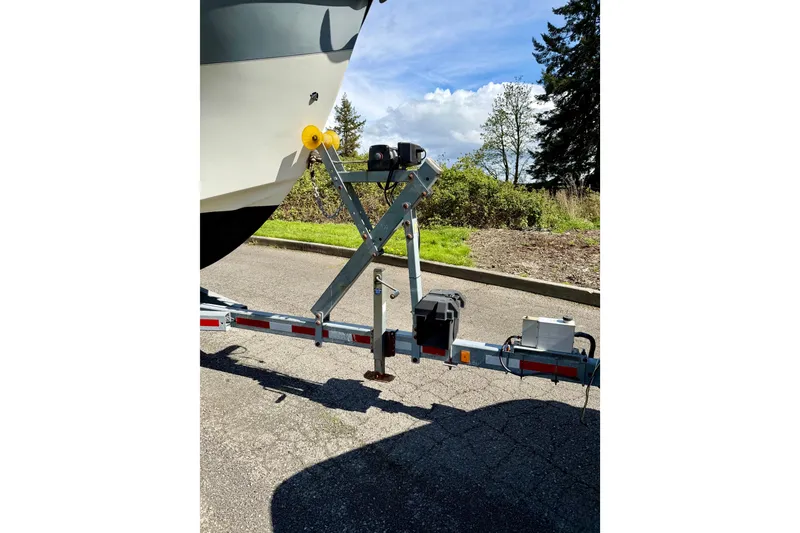 Slide: The Image of Boat trailer with Osprey Legend 2006, parked on sunny day near greenery. - 25
