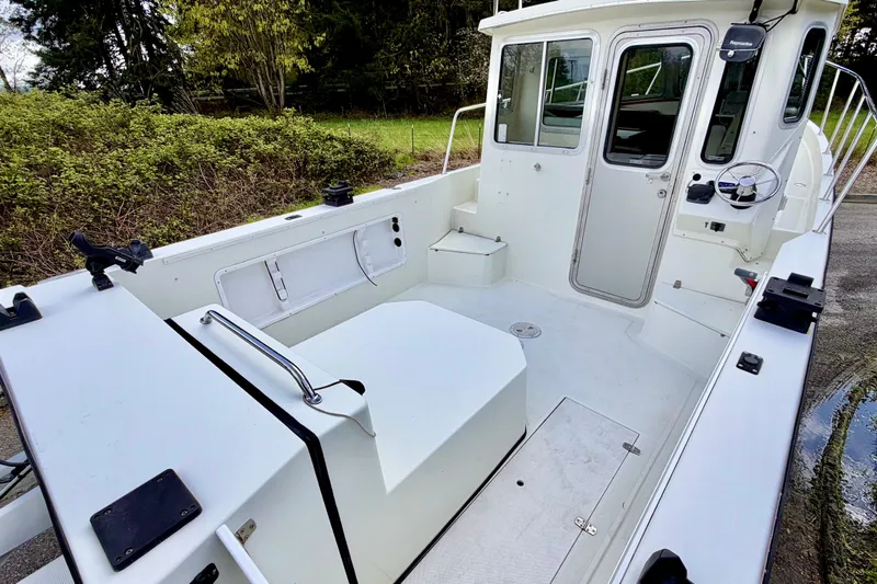 Slide: The Image of 2006 Osprey Legend boat interior with spacious deck and steering console. - 6