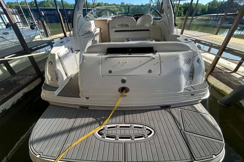 Slide: The Image of 2004 Sea Ray 360 Sundancer boat interior with white seating and table. - 10