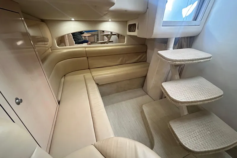 Slide: The Image of Luxurious interior of 2004 Sea Ray 360 Sundancer with beige seating and wooden table. - 17