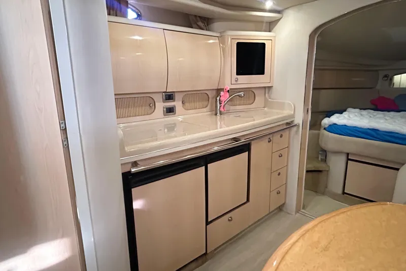 Slide: The Image of Luxurious cabin interior of 2004 Sea Ray 360 Sundancer with cozy bedding and mirrors. - 18