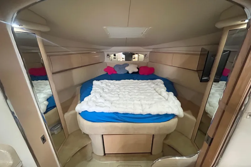 Slide: The Image of Interior of 2004 Sea Ray 360 Sundancer yacht with beige seating and wooden cabinetry. - 20